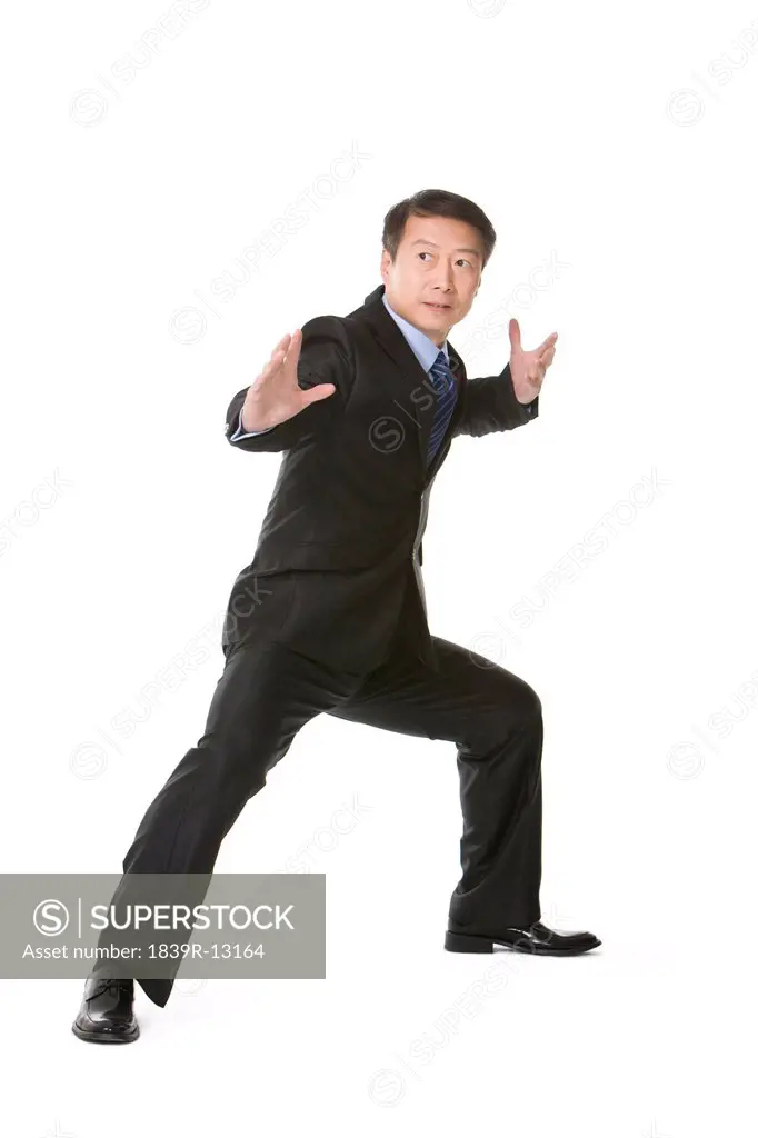 Mature businessman in martial arts fighting stance