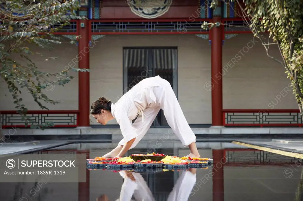 Woman Stretching In Middle Of A Pond