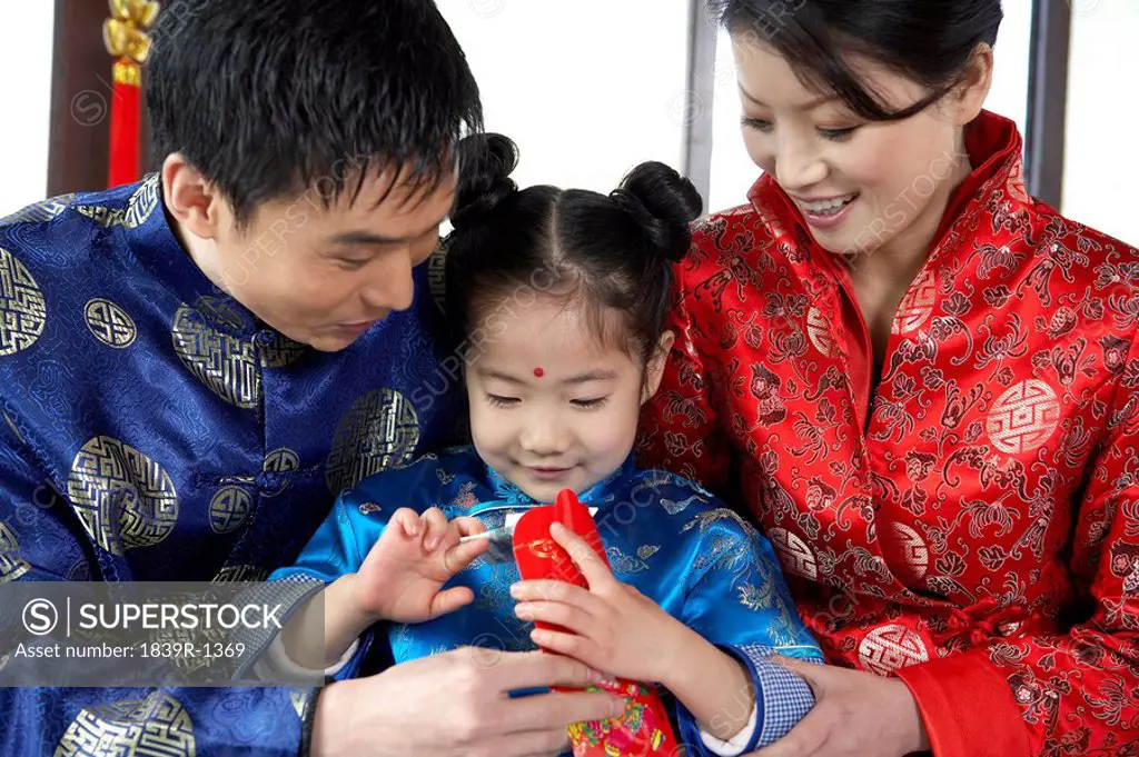 Parents Giving Daughter Envelope During Chinese New Year Celebrations