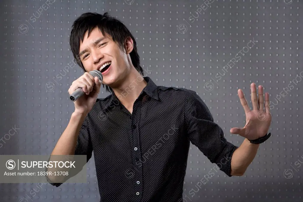 Young man singing karaoke