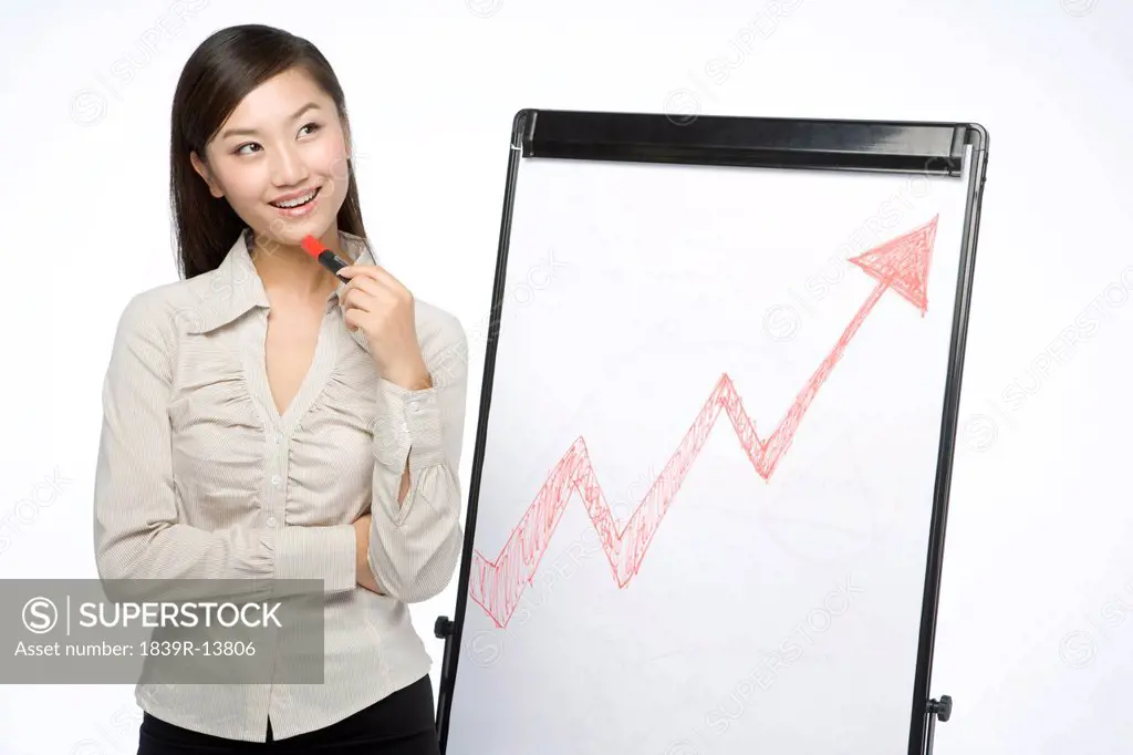 Businesswoman standing by whiteboard