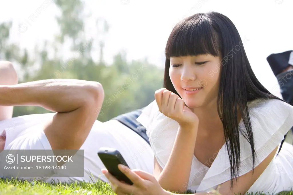 Young woman using cellphone outdoors