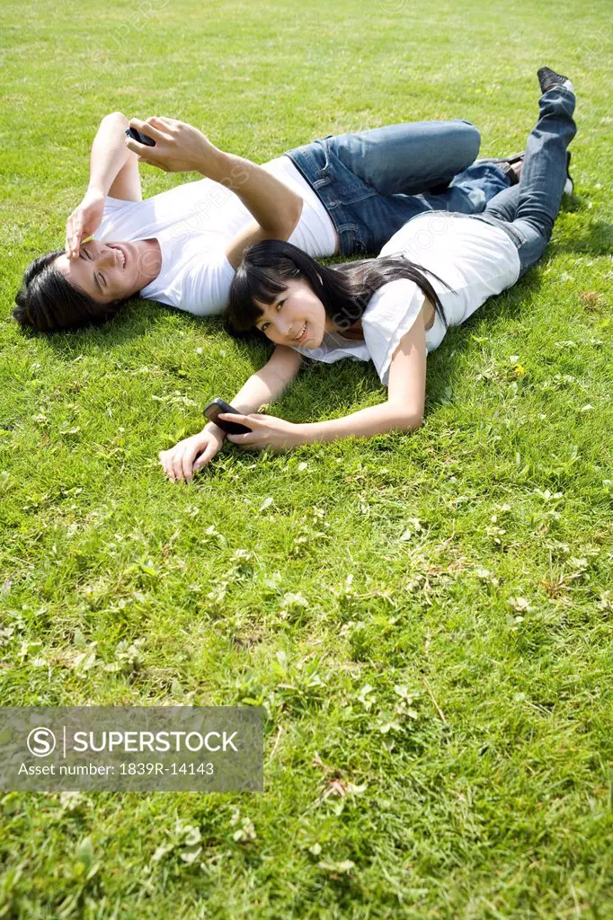 Young couple using cellphone outdoors