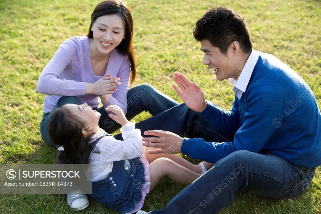 Young family playing in the park