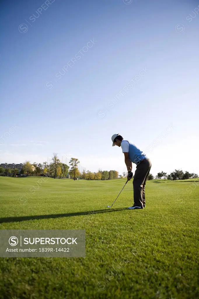 Man teeing off on the course