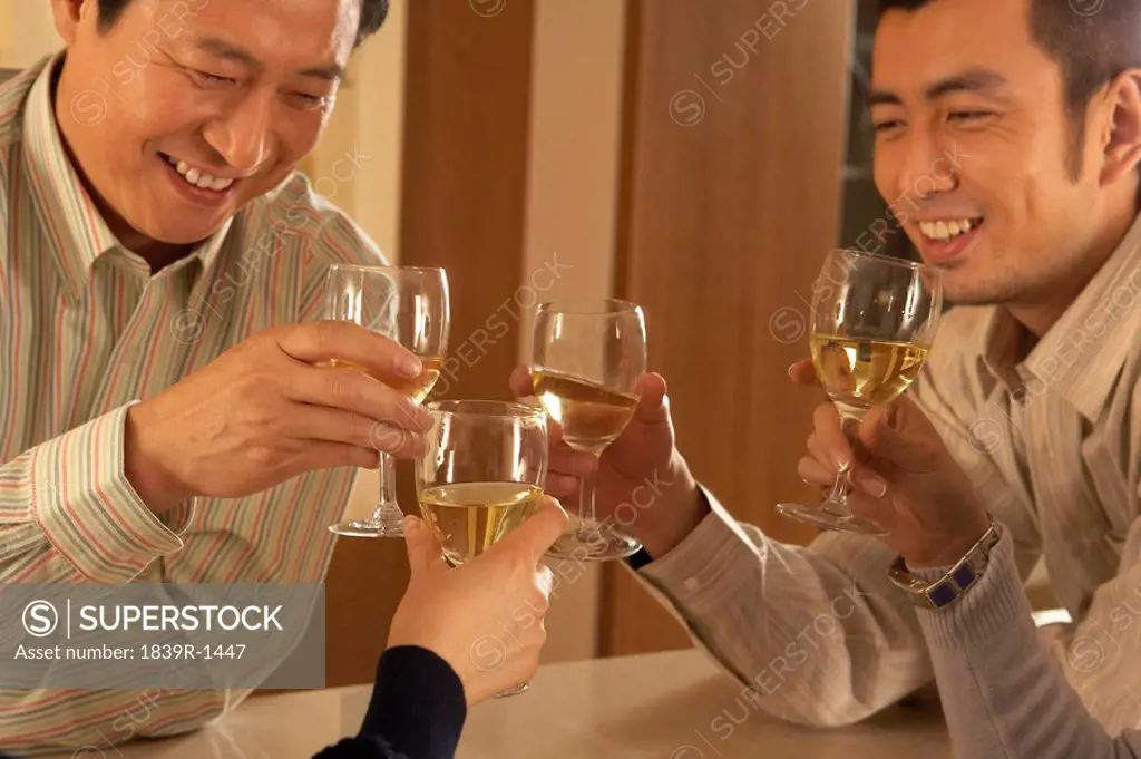 People Toasting With Wine Glasses