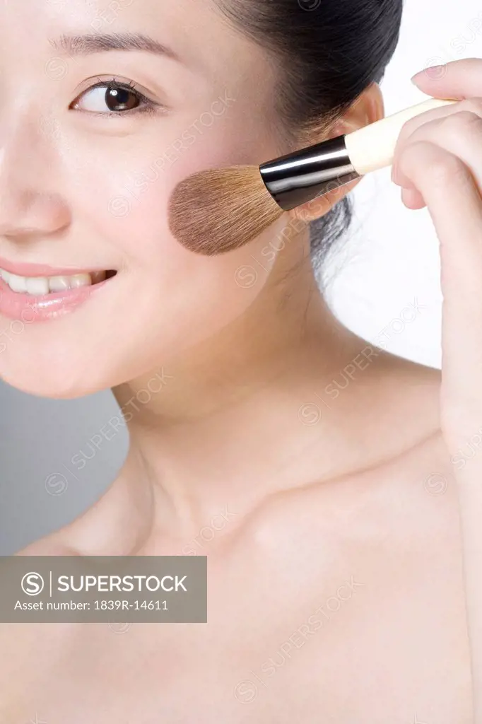 Beauty shot of a young woman with a blusher