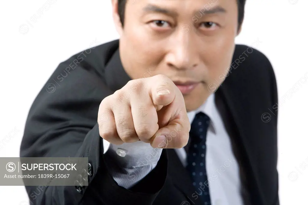 Businessman pointing the front by finger