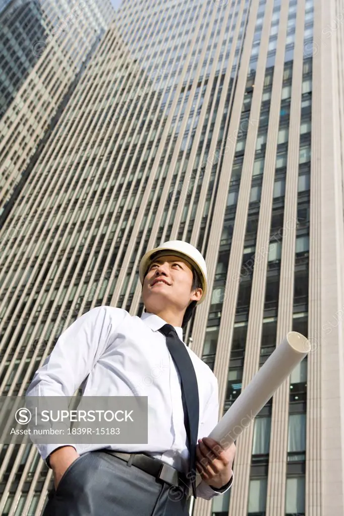 Businessman standing in front of skyscraper