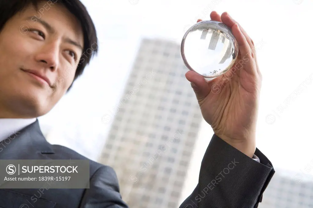 Businessman holding crystal ball