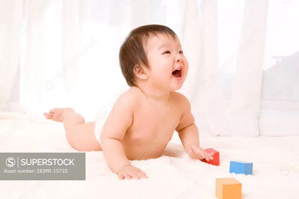 Baby playing with toy blocks