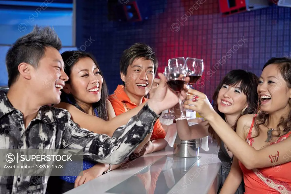 Group Of Friends In A Nightclub, Toasting