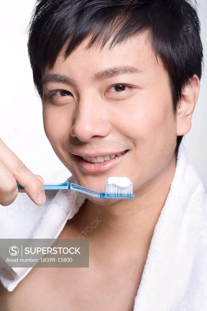 Young man using tooth brush