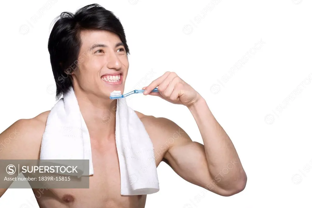 Young man using tooth brush