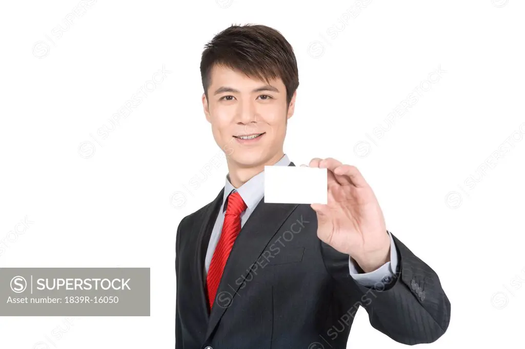 Young businessman holding a blank business card