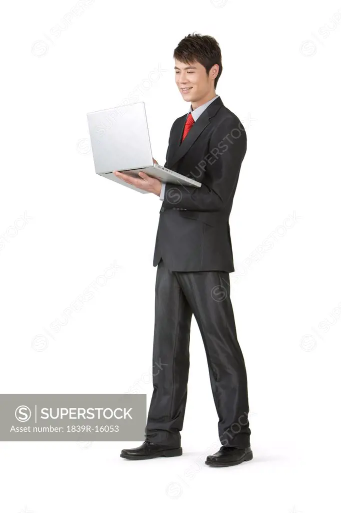 Young businessman holding a laptop