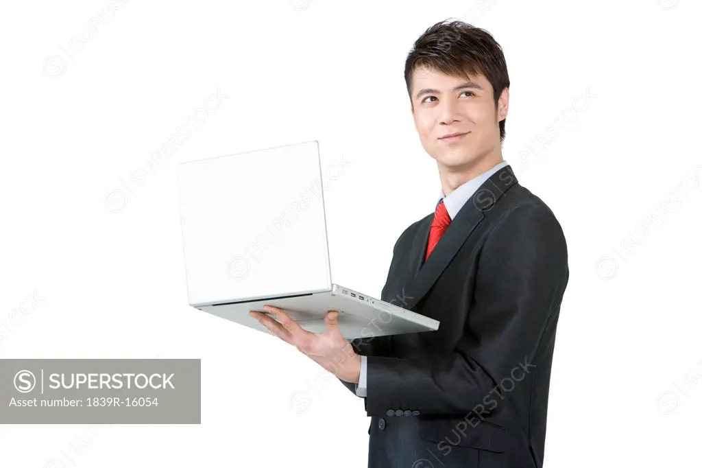 Young businessman holding a laptop
