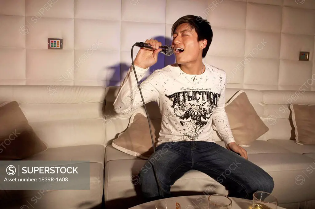 Young Man Passionately Singing Karaoke