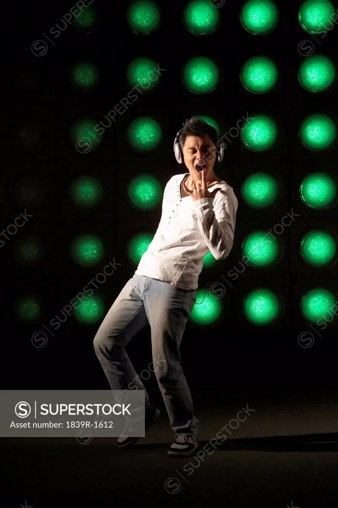 Young Man Performing On Illuminated Stage