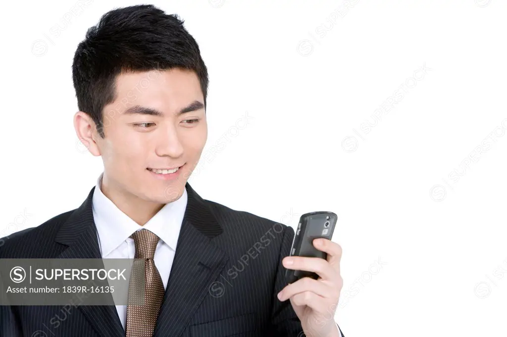 Young businessman text messaging