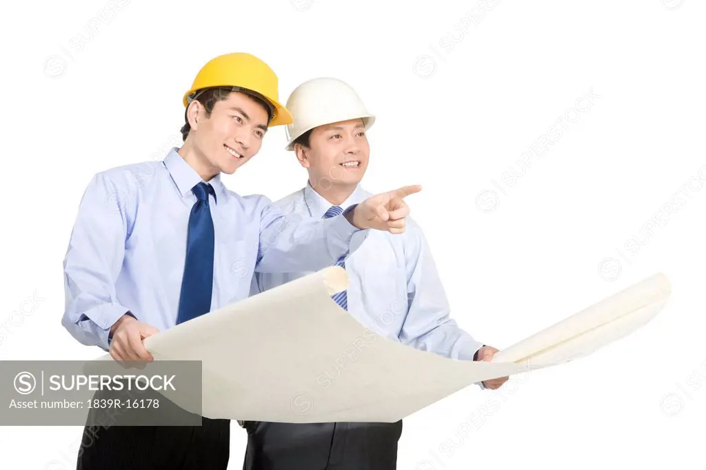 Construction management looking at blueprints
