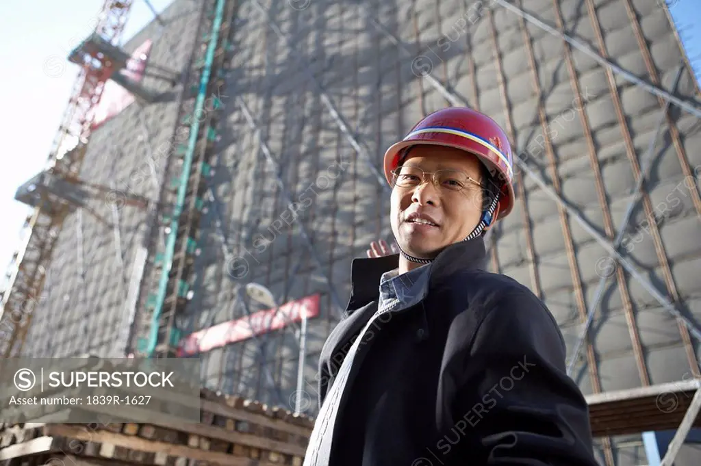 Businessman In Construction Site Wearing Hard Hat