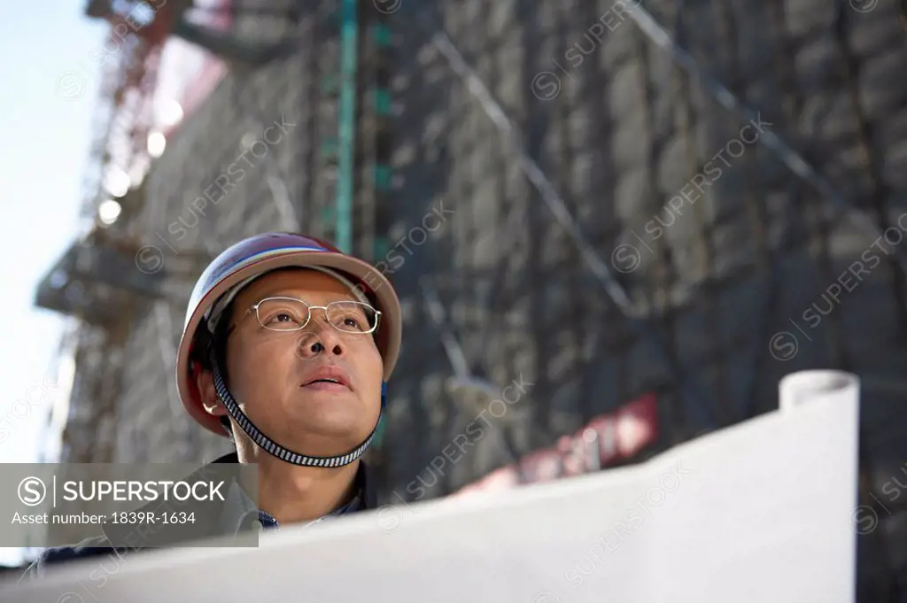 Businessman In Construction Site Wearing Hard Hat