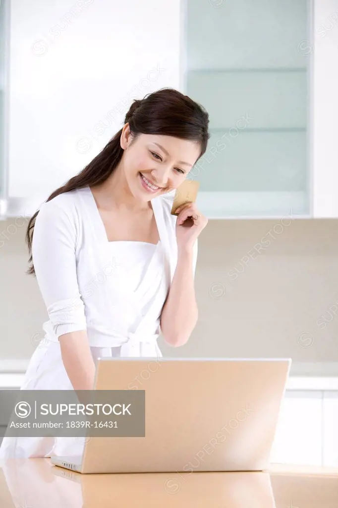 Young woman internet shopping from home