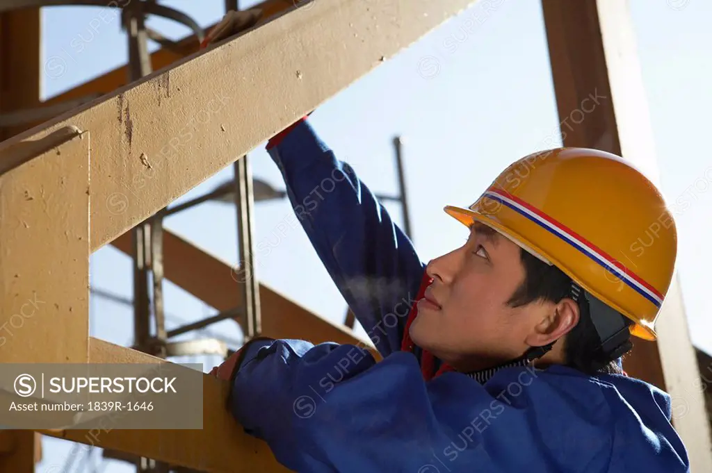 Worker Wearing Hard Hat In Construction Site