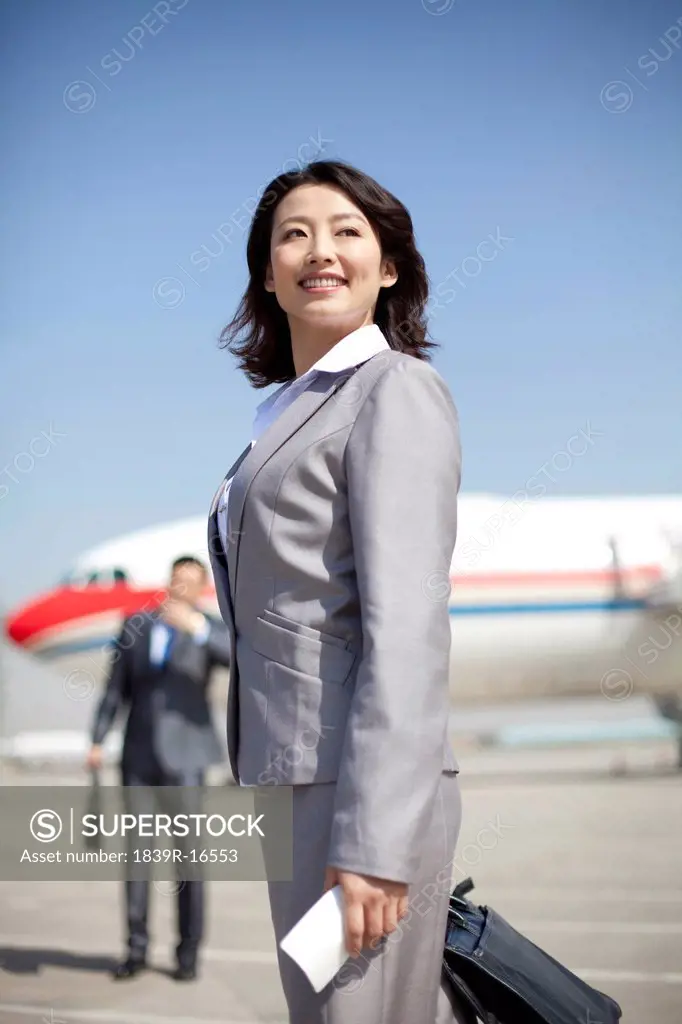 Businesswoman on the airplane runway