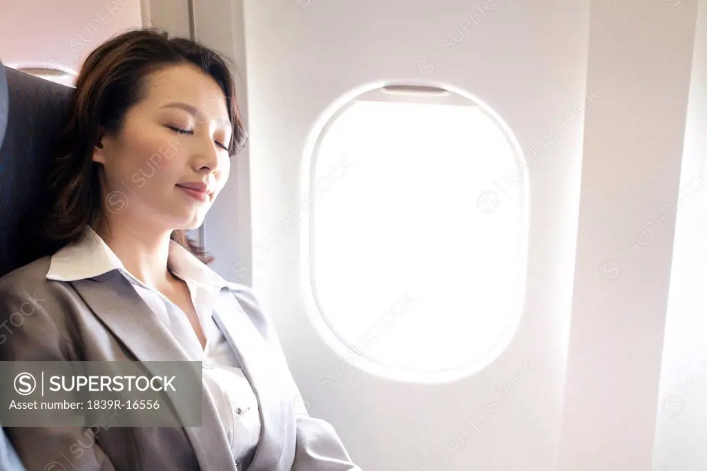 Businesswoman resting on the flight