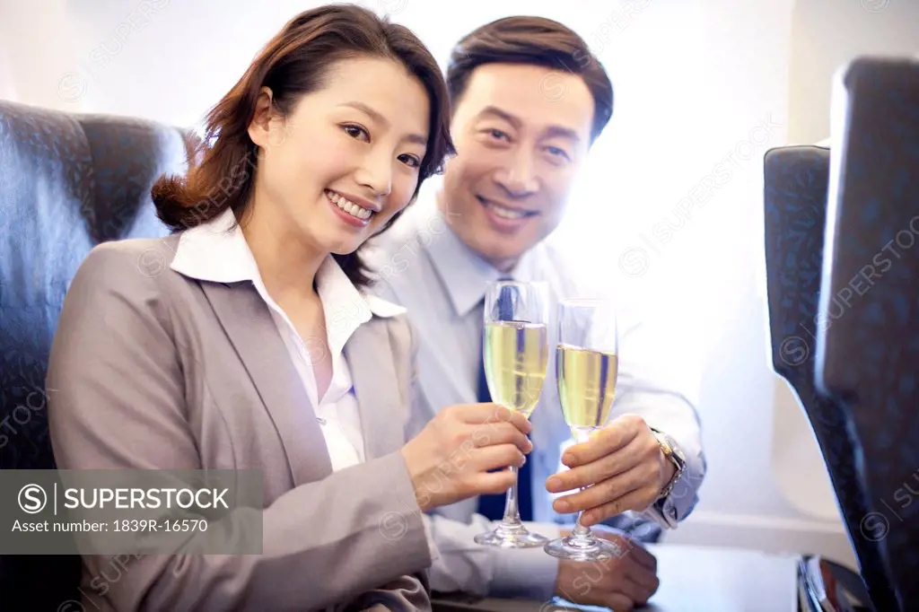 Businesspeople toasting champagne on the plane