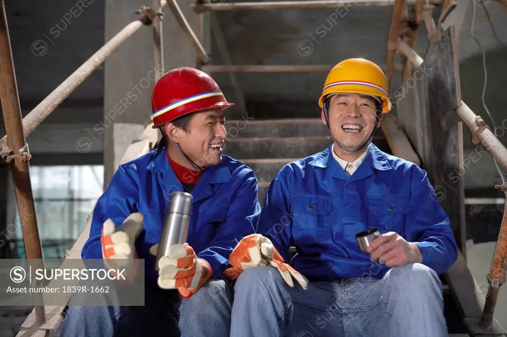 Men In Construction Site Wearing Hard Hats