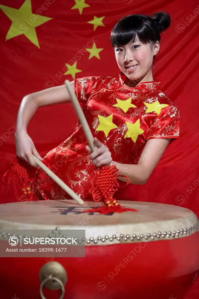 Traditionally Dressed Woman Playing Chinese Drum