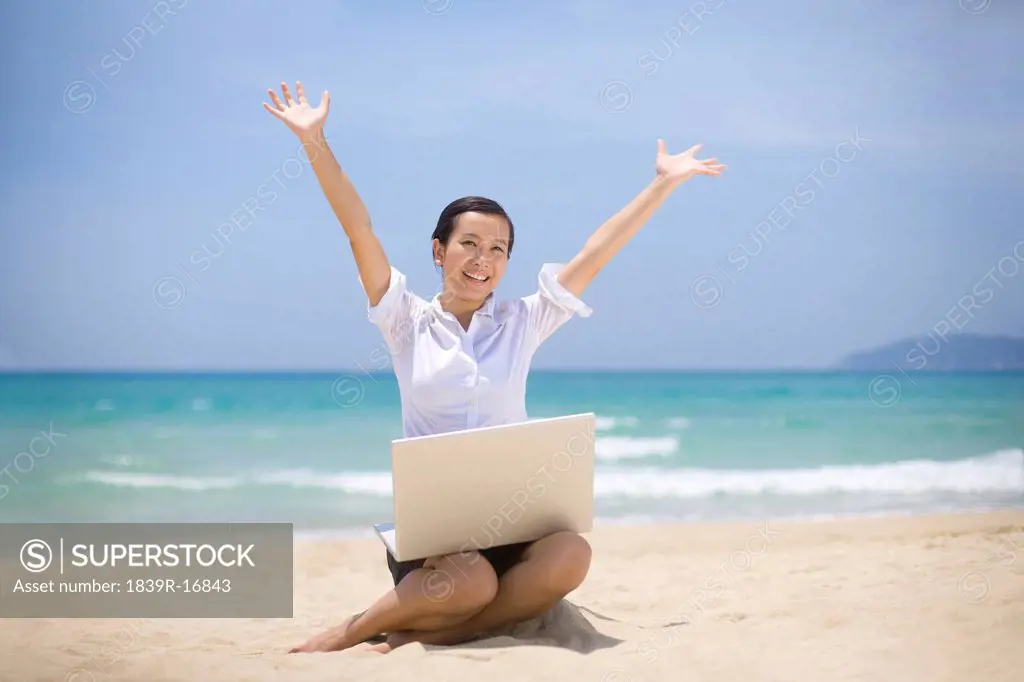 Businesswoman working on the beach