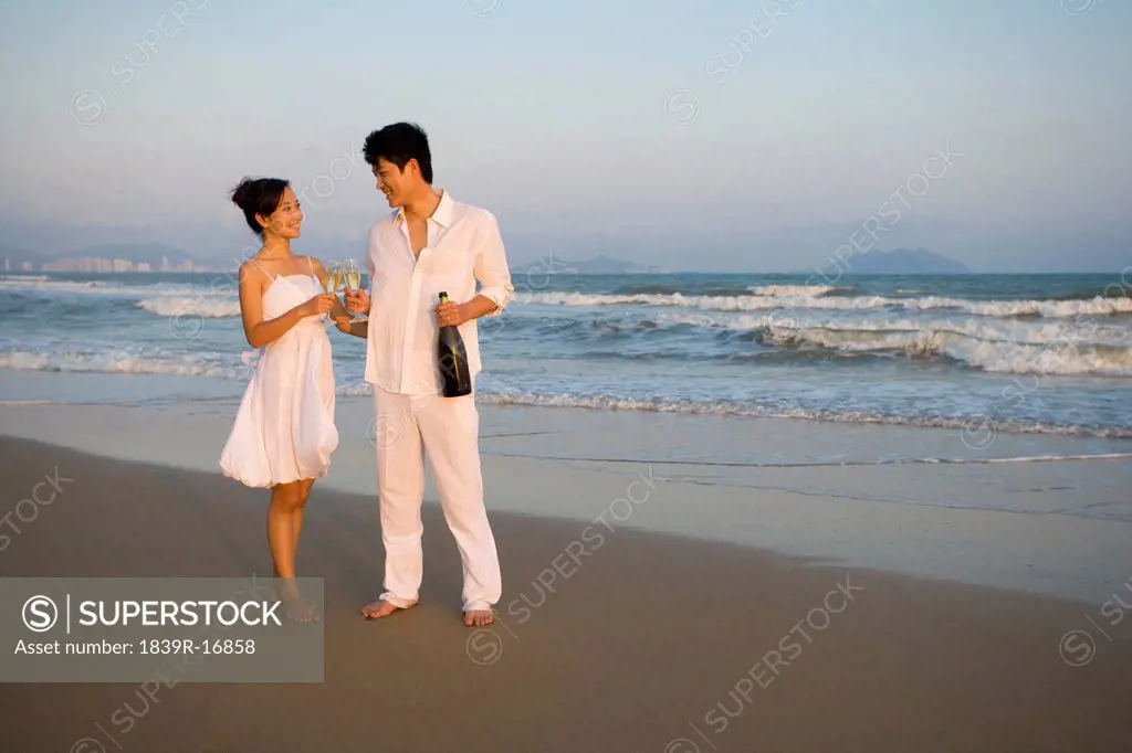 Young couple celebrating with a bottle of champagne