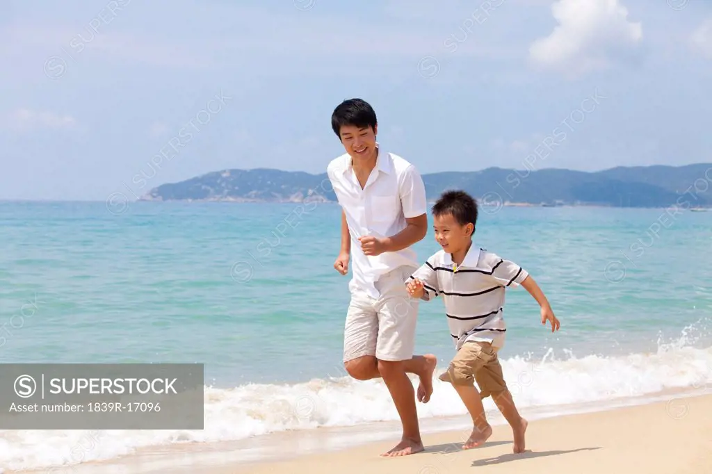 Father and son playing on the beach