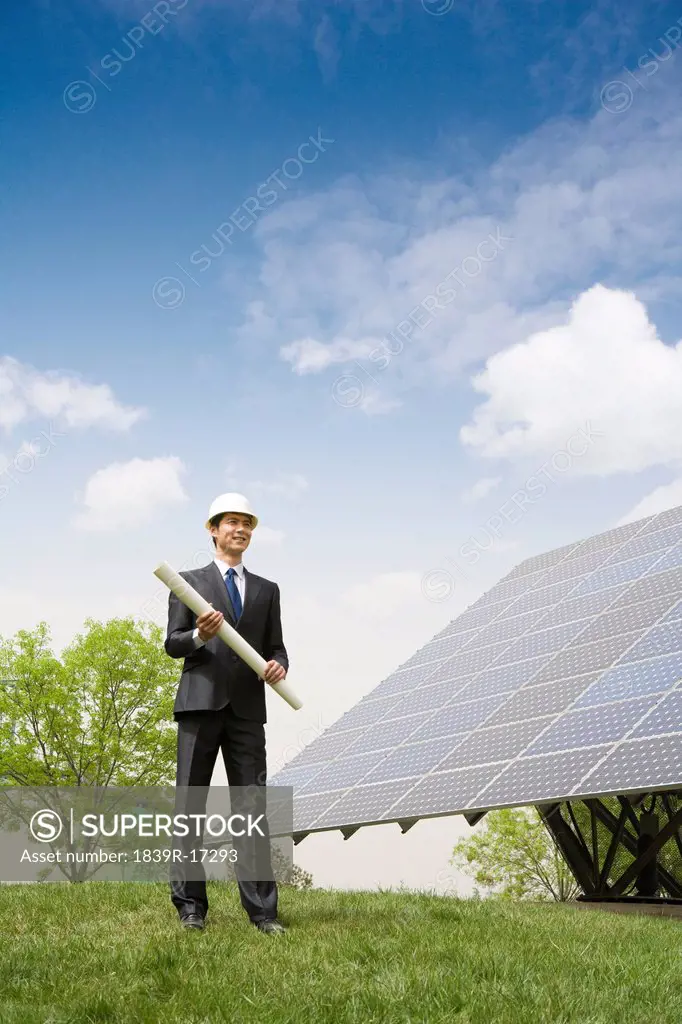 Portrait of an engineer in front of solar panels