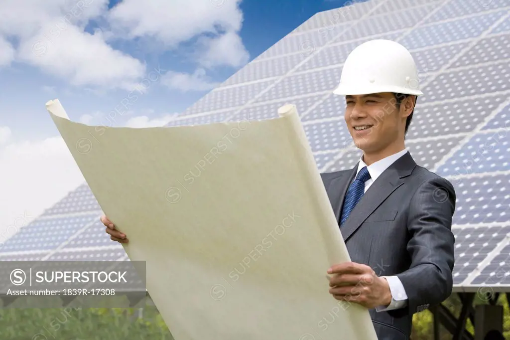 Portrait of an engineer in front of solar panels