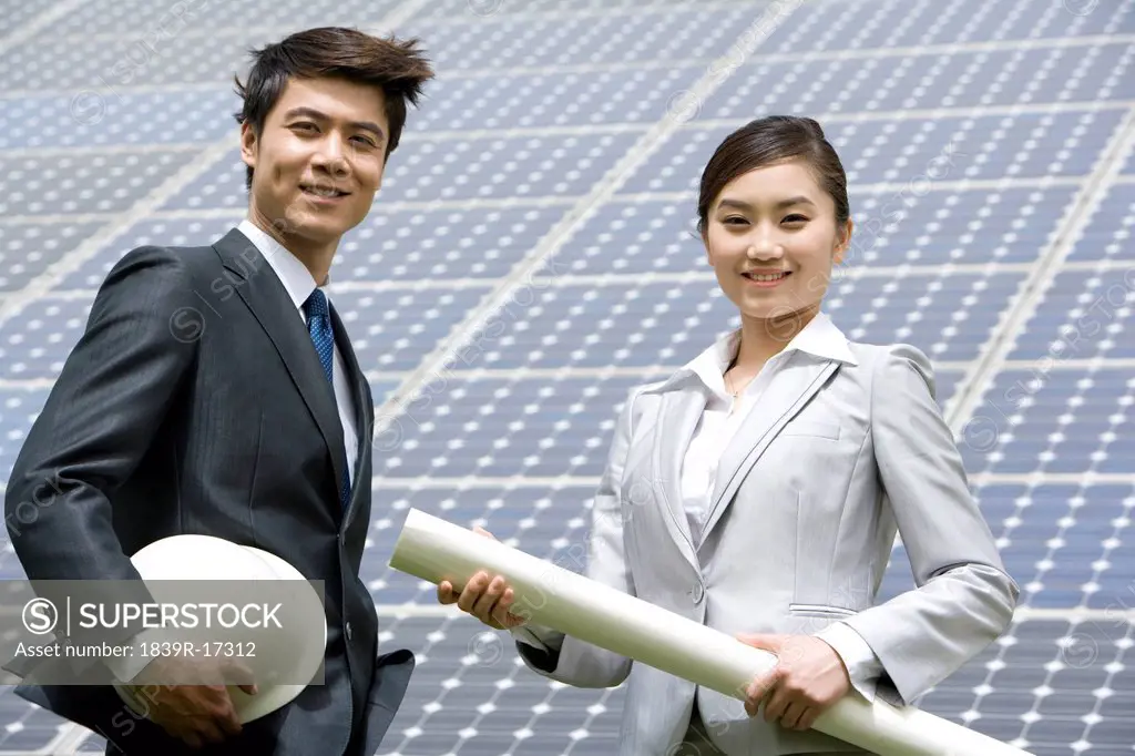 Two engineers in front of solar panels