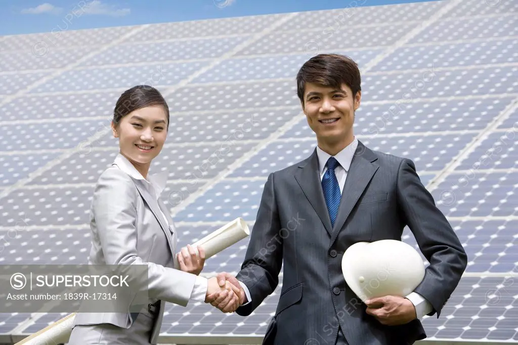 Two engineers in front of solar panels