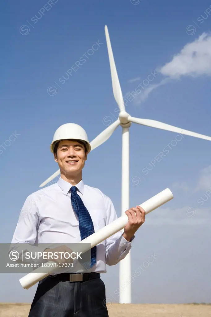 Engineer in front of wind turbines