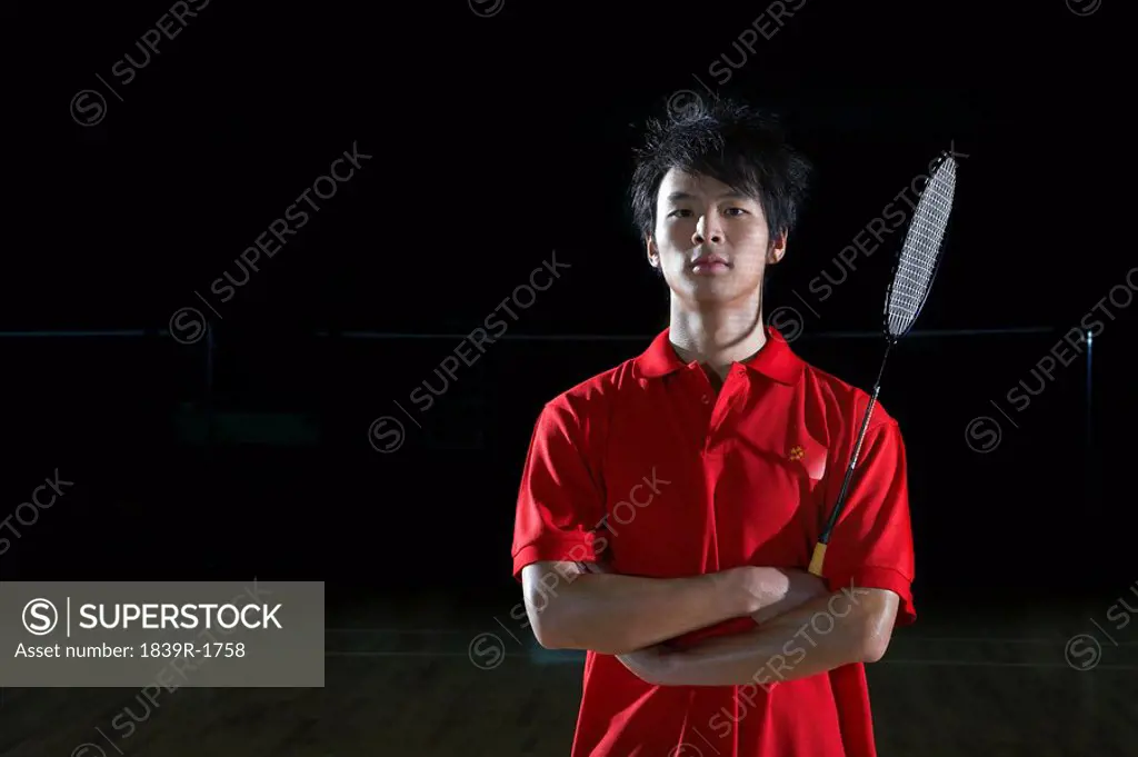 Young Man Poses Holding His Badminton Racket