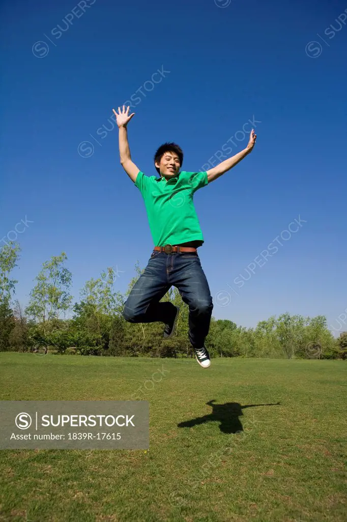 Young man jumping in air at park