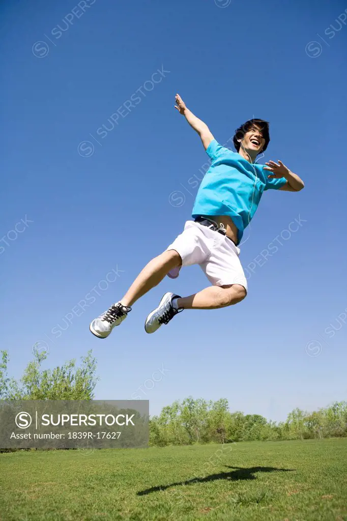 Young man jumping in air at park
