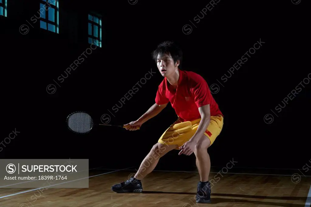 Young Man Playing A Game Of Badminton