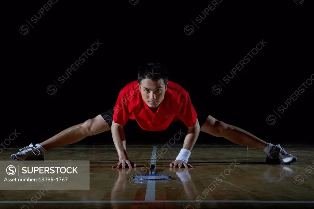 Young Man Stretching During A Game Of Badminton
