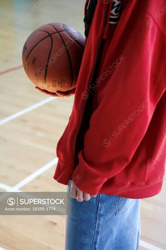 Young Man Holding A Basketball