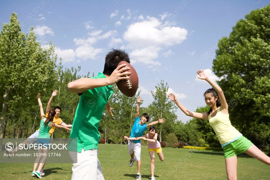 Group of friends playing American Football