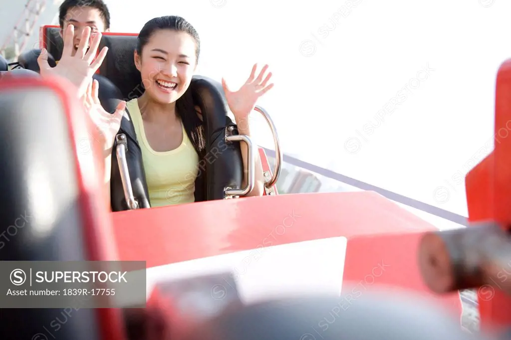 Young people riding a rollercoaster